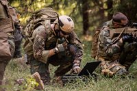Man-in-the-Military-Using-Laptop-and-Walkie-Talkie.jpeg